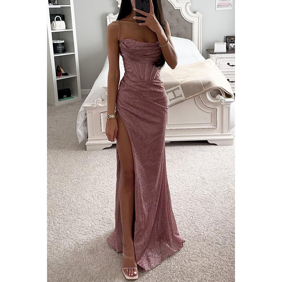 Woman in a sparkly pink dress taking a mirror selfie in a bedroom.