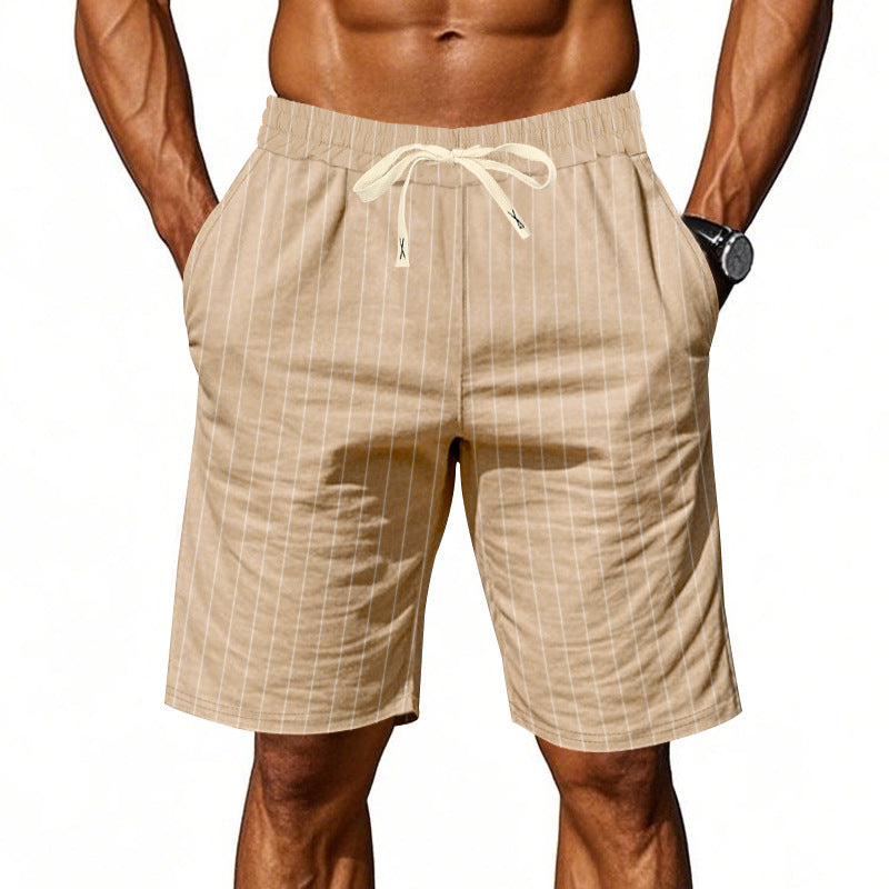 Beige striped shorts worn by a person on a white background