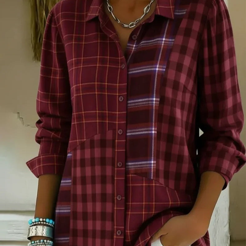 Person wearing a red plaid shirt with a neutral background