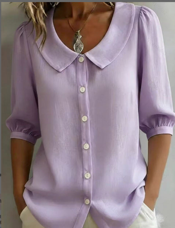 Purple blouse with a collar and buttons on a neutral background