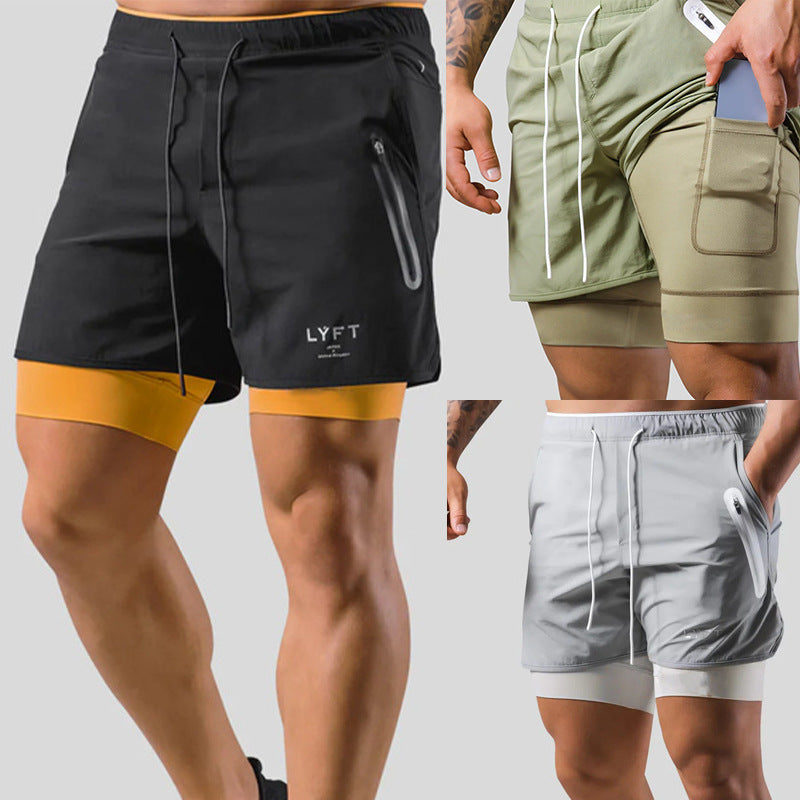 Two pairs of shorts, one black with yellow lining and the other green with white lining, on a neutral background.