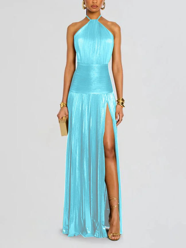 Woman wearing a turquoise halter neck gown with a high slit on a light gray background