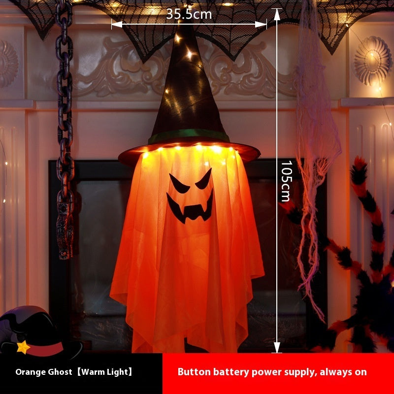 Halloween-themed orange ghost decoration with a witch hat, glowing warmly, on a decorative background.