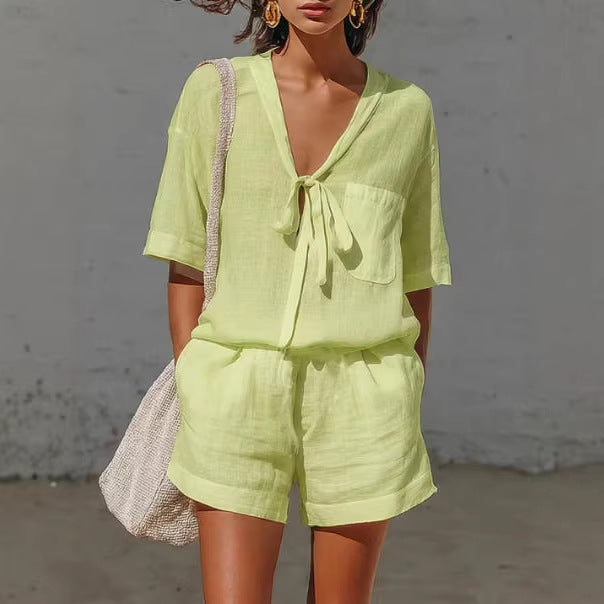 Woman wearing a light green outfit with a plain background