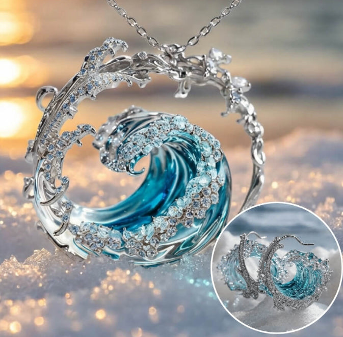 Wave-shaped necklace with blue center and silver accents on a blurred background