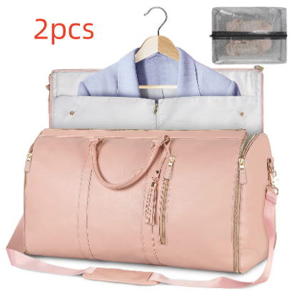 Pink duffel bag with clothes and a hanger, accompanied by a clear travel organizer.