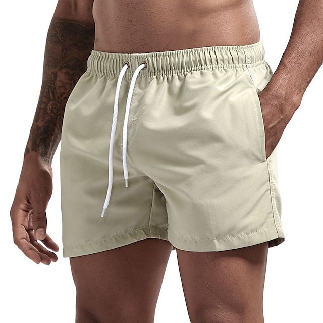 Beige swim shorts with a white drawstring on a white background