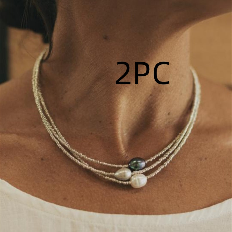Necklace with three beads worn by a person, labeled '2PC'.