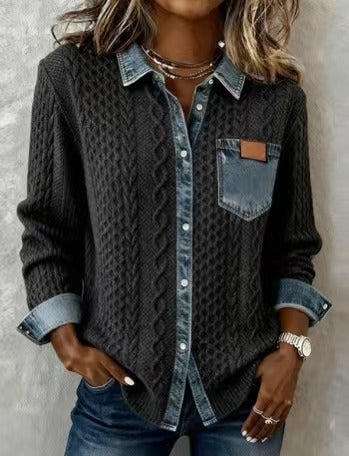 Person wearing a dark cable knit shirt with denim accents against a neutral background