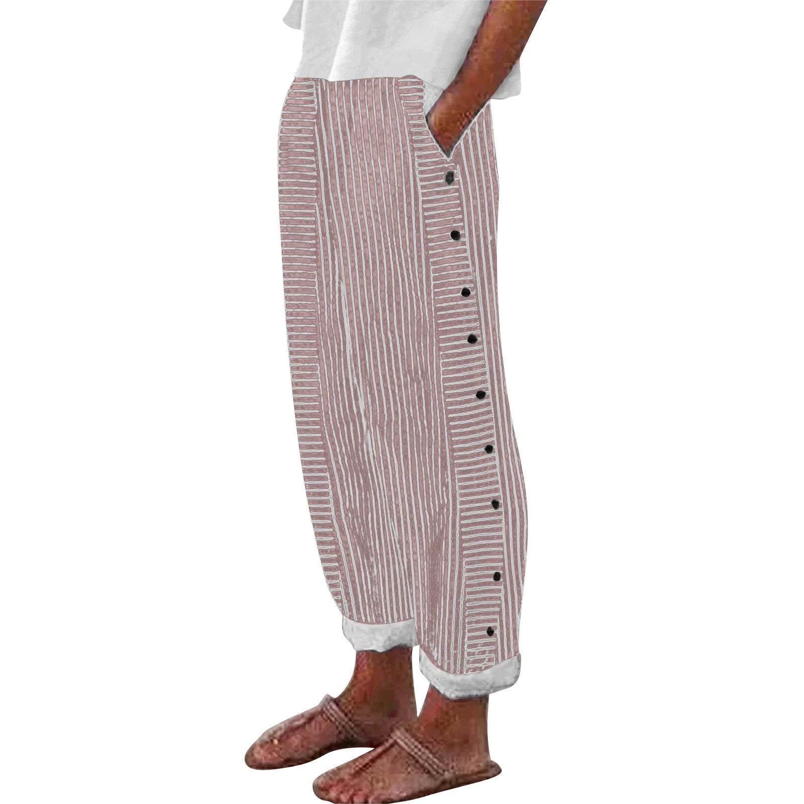 Striped pants with buttons worn by a person on a white background