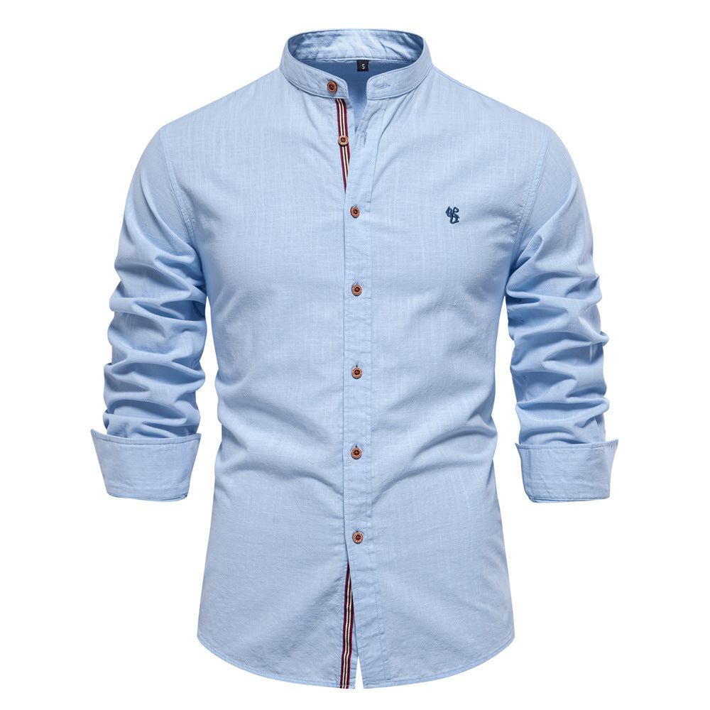 Light blue button-up shirt with rolled-up sleeves on a white background