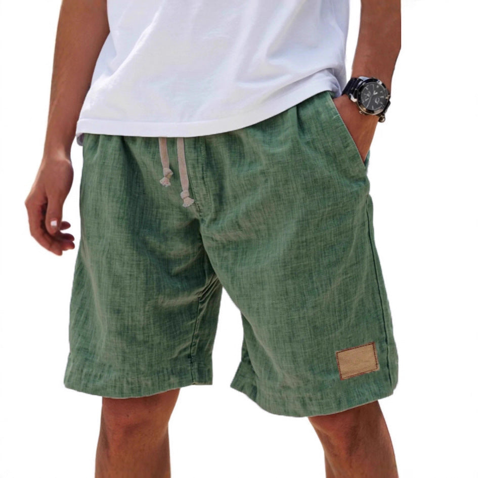 Green shorts worn by a person on a white background