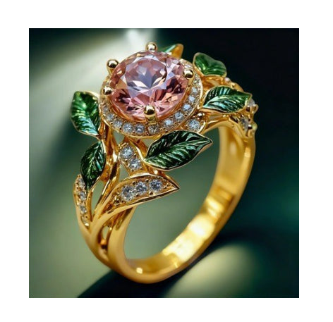 Gold ring with a pink gemstone and green leaf designs on a dark background