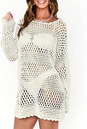 Woman wearing a white crochet dress on a plain background
