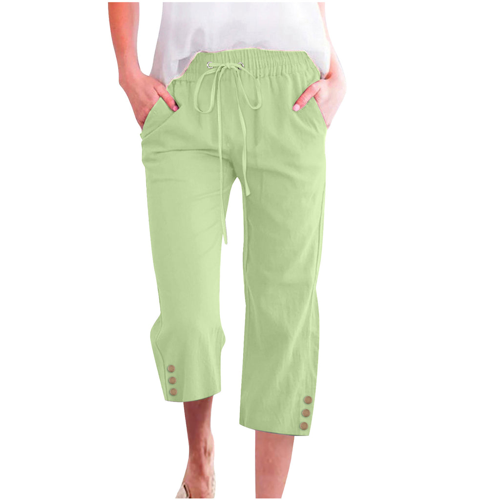 Light green capri pants with buttons on a white background