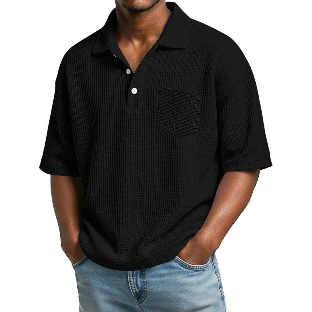 Man wearing a black textured short-sleeve shirt with a white background