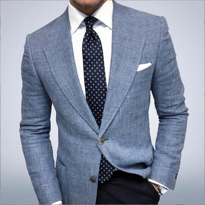 Blue suit jacket with a white shirt and patterned tie on a gray background