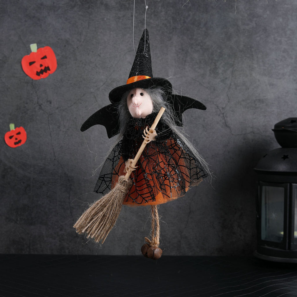 Halloween-themed decoration with a mouse dressed as a witch on a broomstick against a dark background.