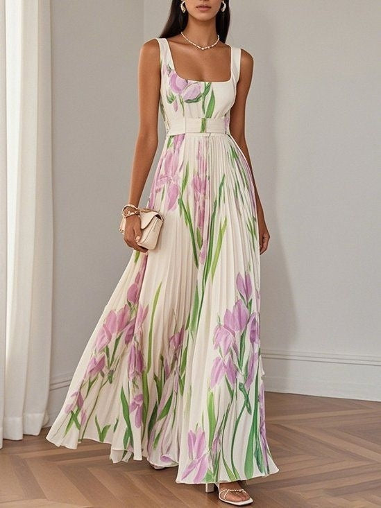 Woman wearing a floral dress in a room with white walls and wooden floor.
