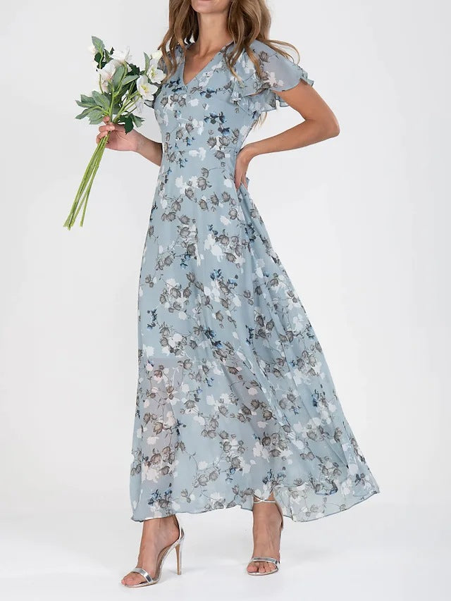 Woman wearing a floral dress holding flowers on a white background