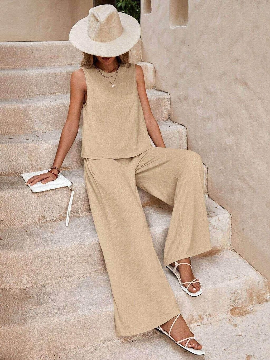 Woman in beige sleeveless set with wide-leg pants, wide-brim hat, and white sandals, ZA-Zola fashion