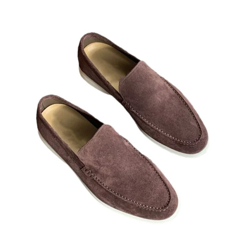 Pair of brown suede loafers on a white background