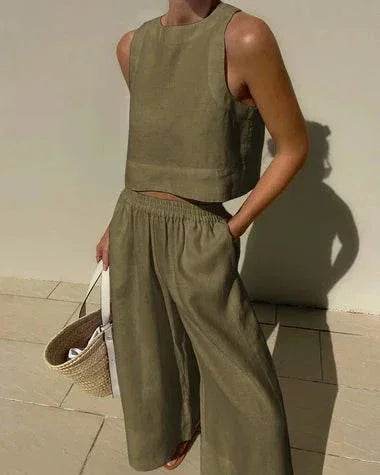 Woman wearing olive green sleeveless crop top and wide-leg pants from ZA-Zola, holding straw bag