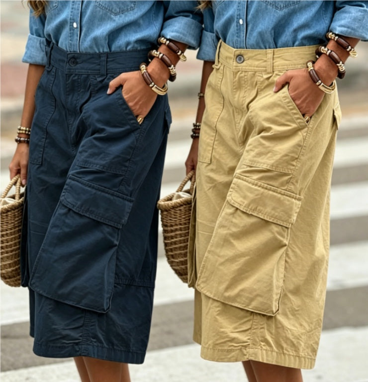 Two people wearing cargo shorts with a blurred background