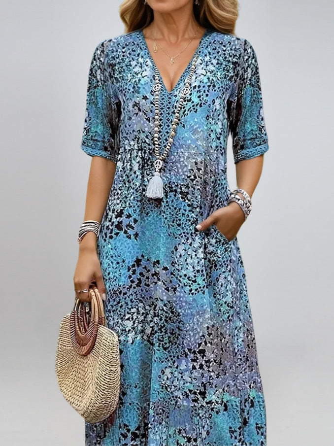 Woman wearing a blue floral dress with a plain background