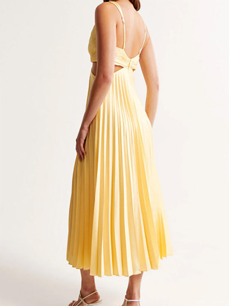 Woman wearing a yellow pleated dress on a white background