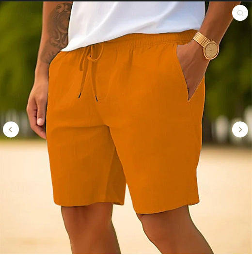 Person wearing mustard yellow shorts with a blurred outdoor background