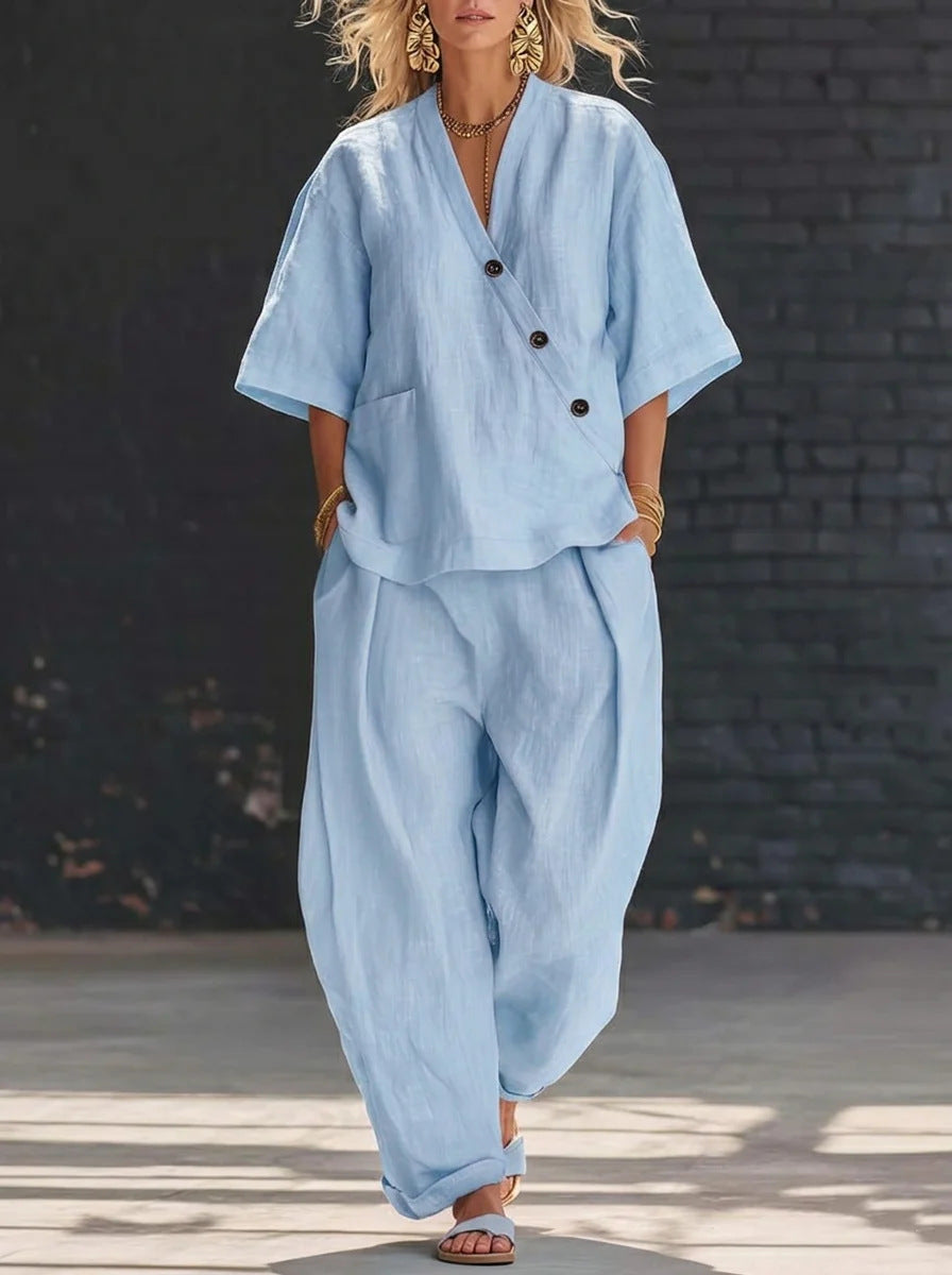 Person wearing a light blue outfit with a black background