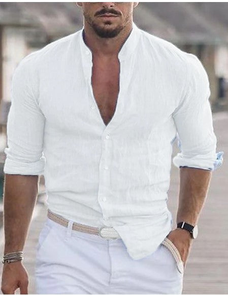 Man wearing a white button-up shirt with rolled-up sleeves and light-colored pants.