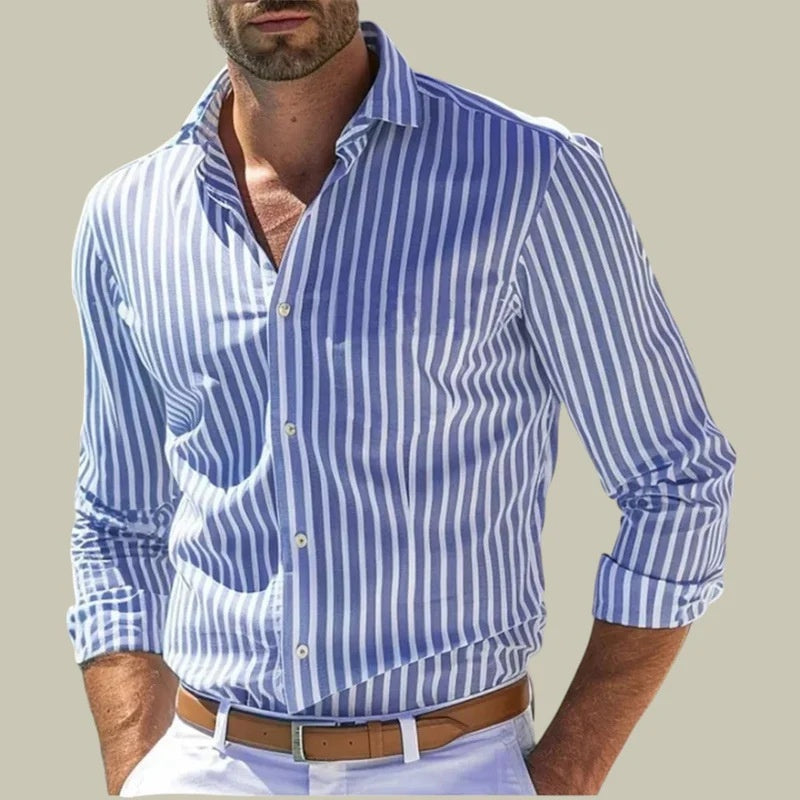 Man wearing a blue and white striped shirt with rolled-up sleeves on a beige background
