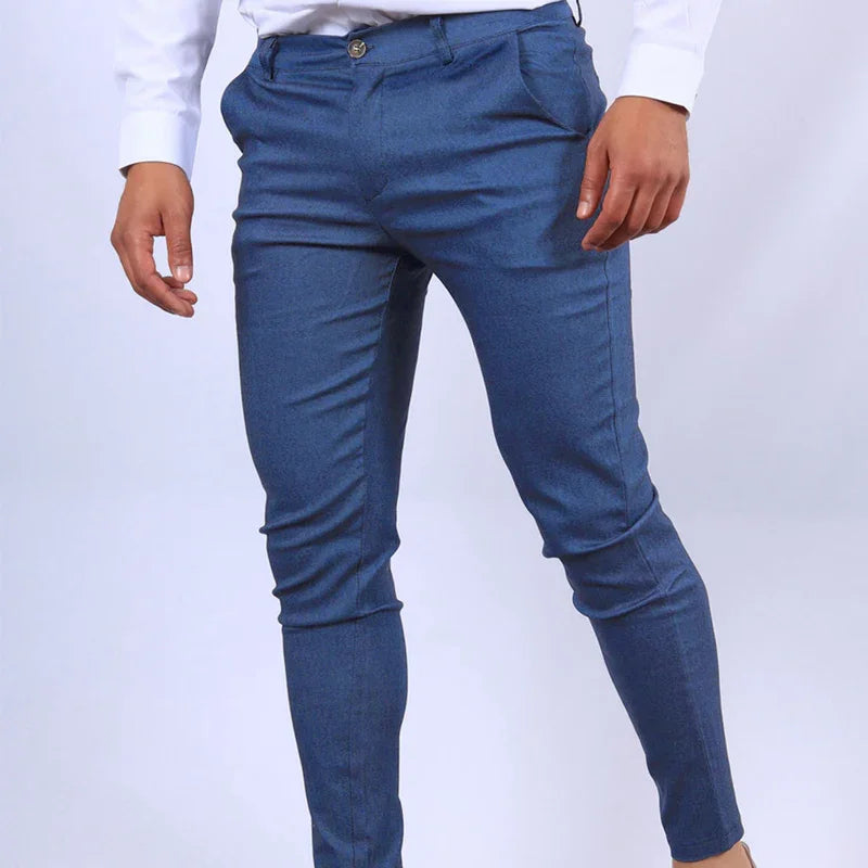 Blue pants worn by a person on a white background