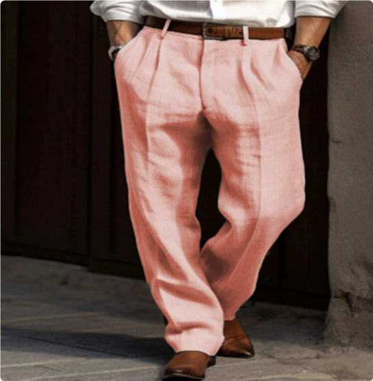 Person wearing pink pants and brown shoes on a dark background