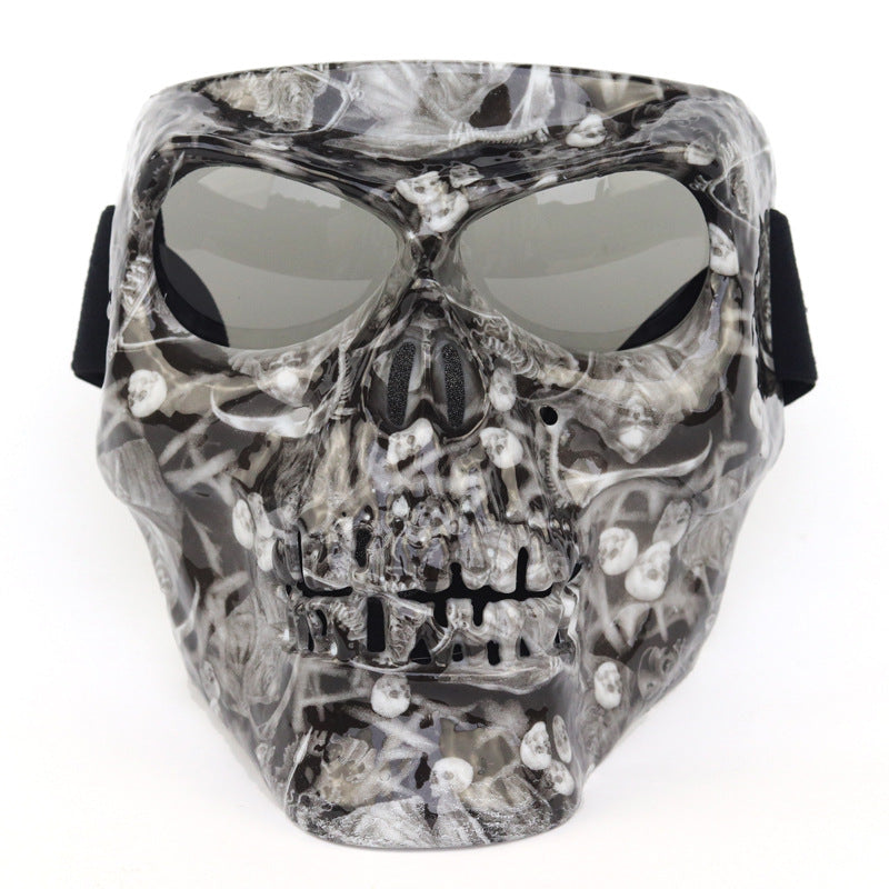 Skull-shaped mask with reflective lenses on a white background