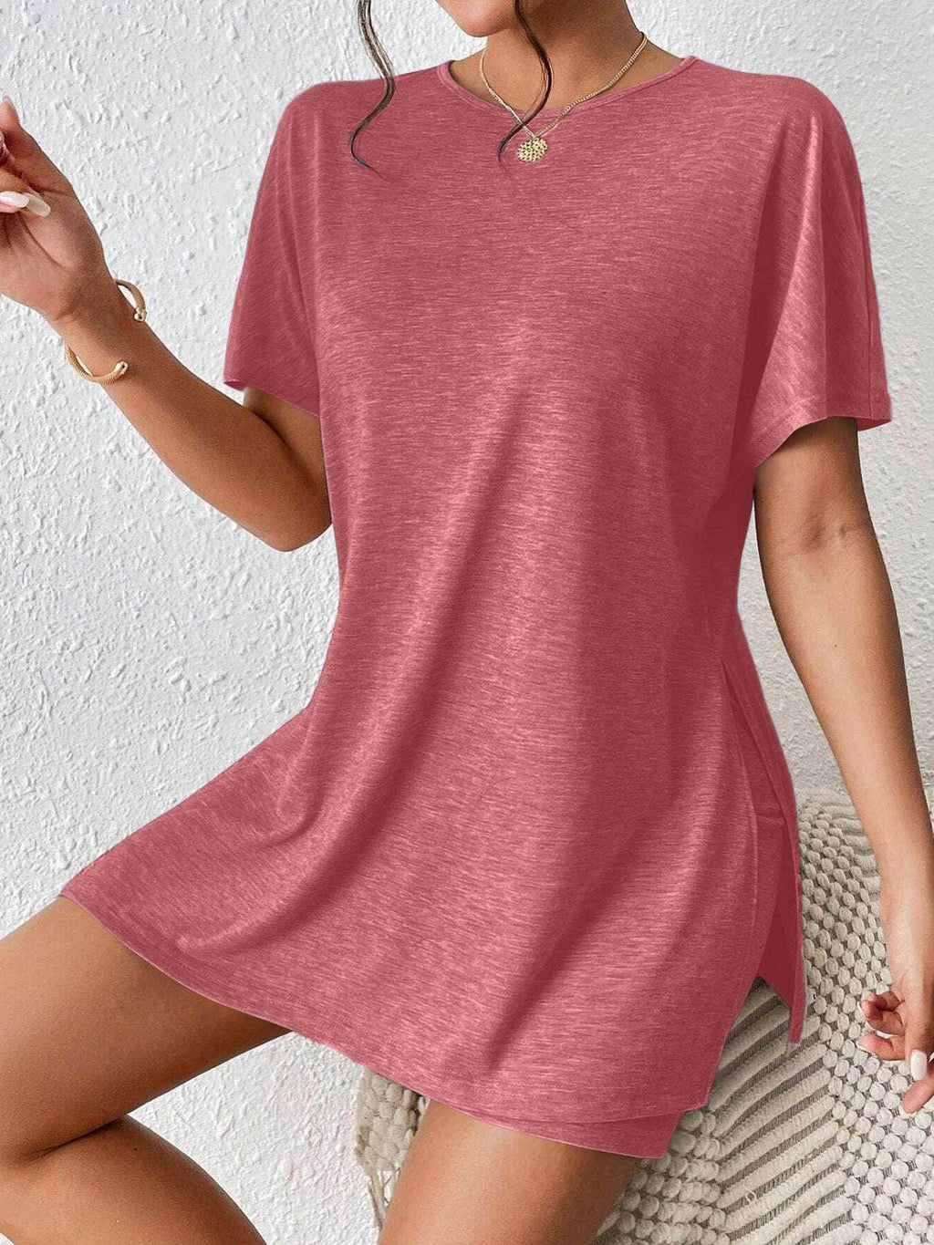 Woman wearing a casual pink short-sleeve T-shirt dress from ZA-Zola, trendy UK fashion