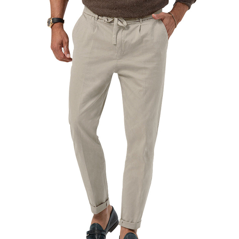 Beige pants worn by a person on a white background