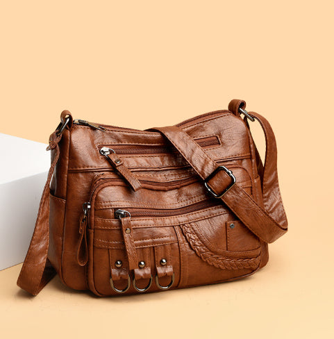 Brown leather handbag on a beige background