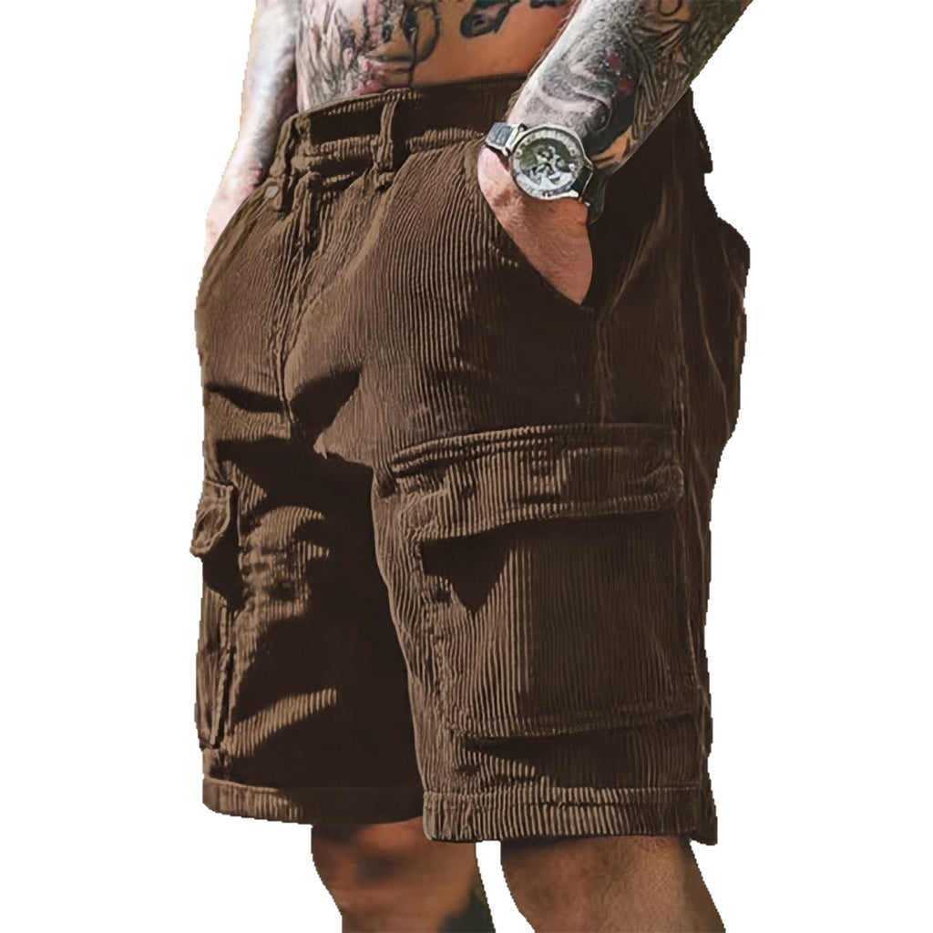 Brown corduroy shorts worn by a person with tattoos on a white background