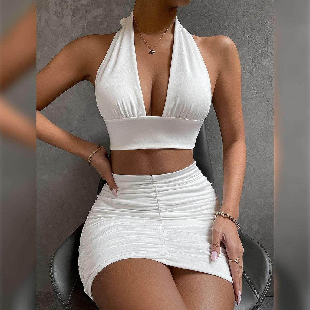Woman modeling a trendy white halter crop top and ruched mini skirt from ZA-Zola
