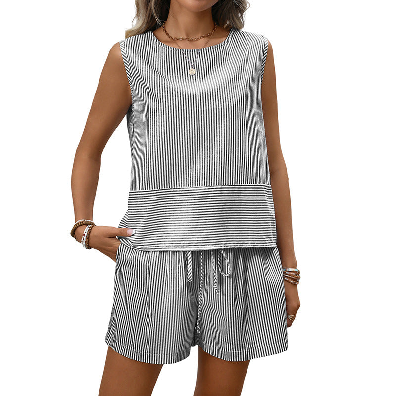 Woman wearing a black and white striped sleeveless top and shorts set on a white background