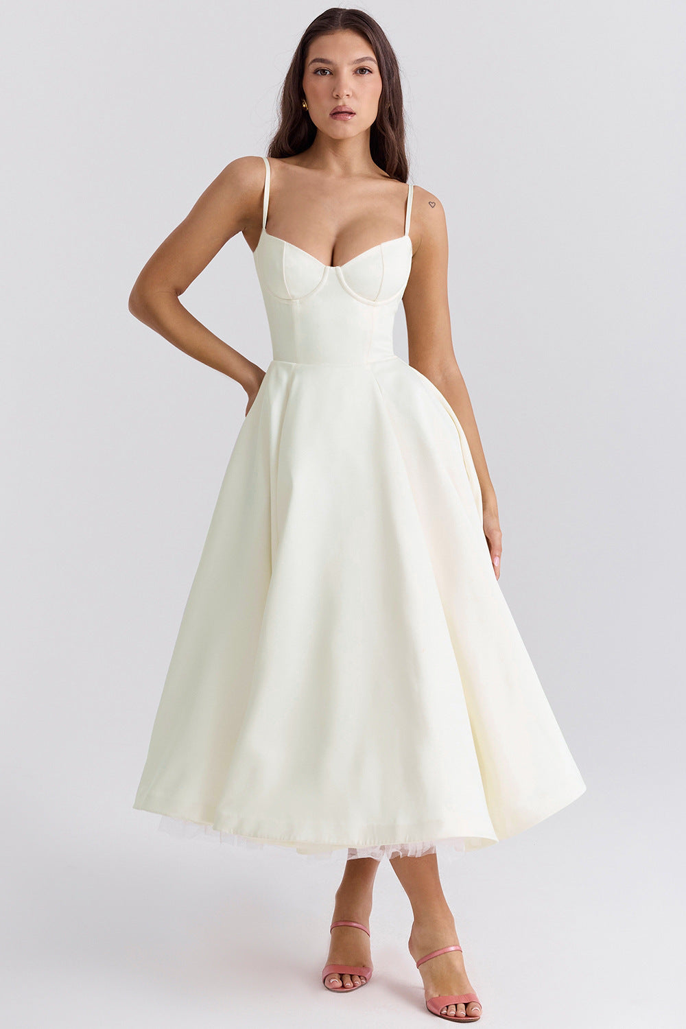Woman wearing a white dress on a plain background