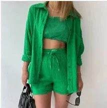 Woman in green three-piece summer set with shirt, crop top, and shorts from ZA-Zola fashion.