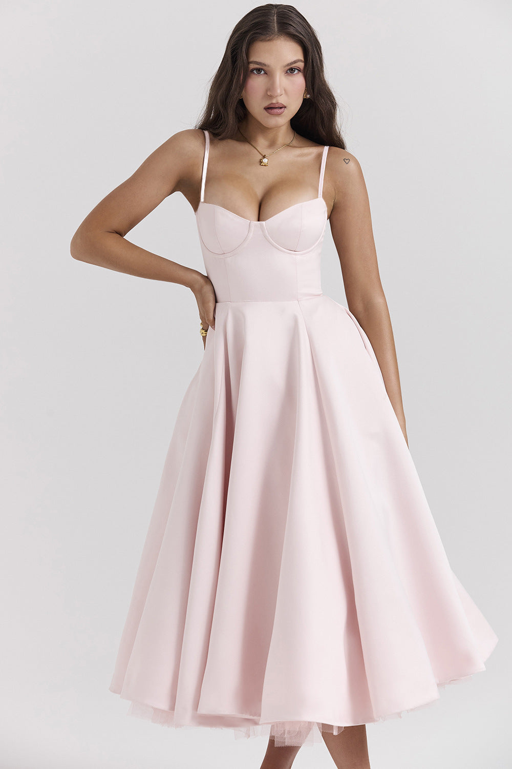 Woman wearing a pink dress against a white background