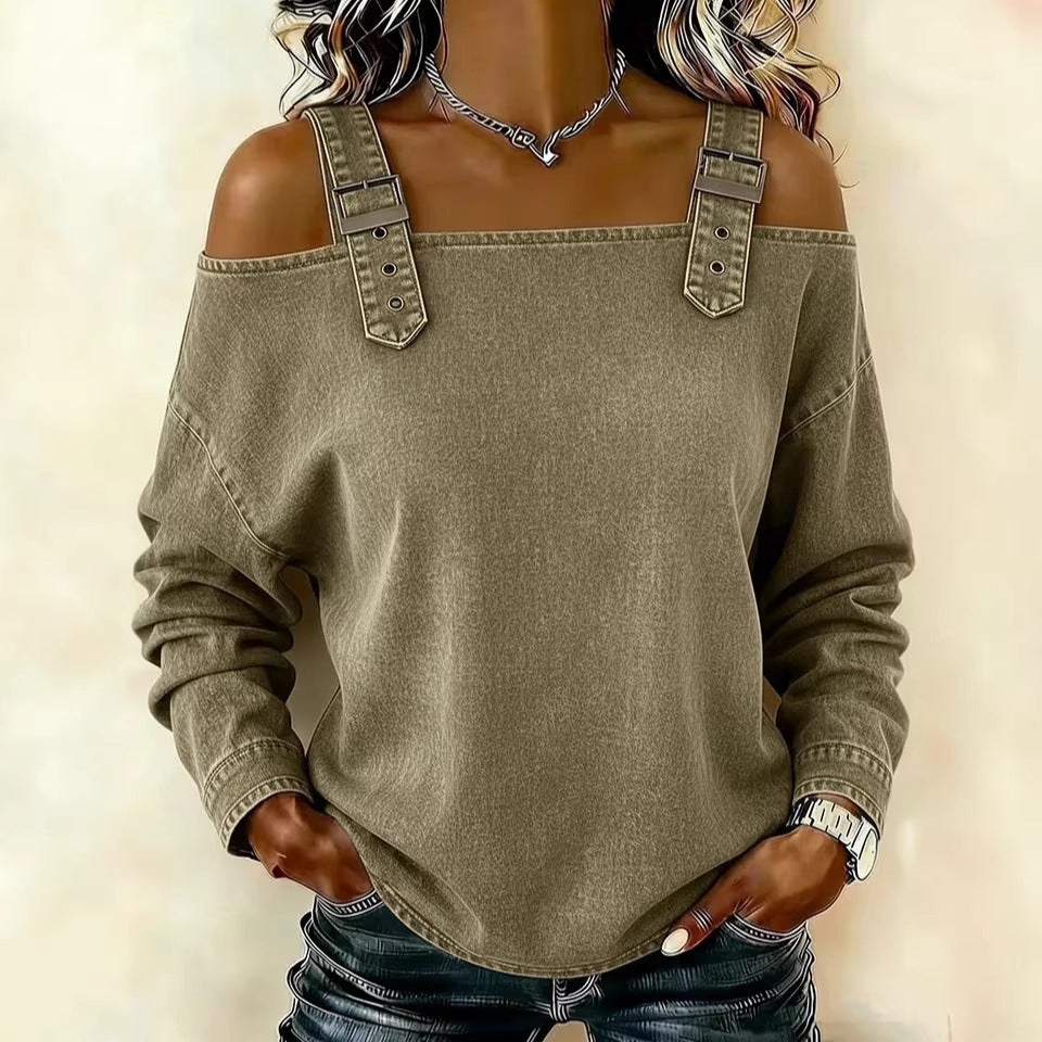 Green off-shoulder sweater with denim details on a plain background