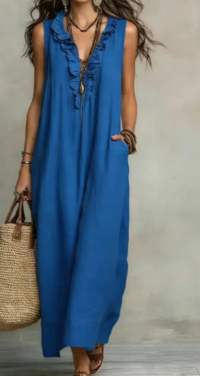Woman wearing a blue sleeveless dress with a neutral background