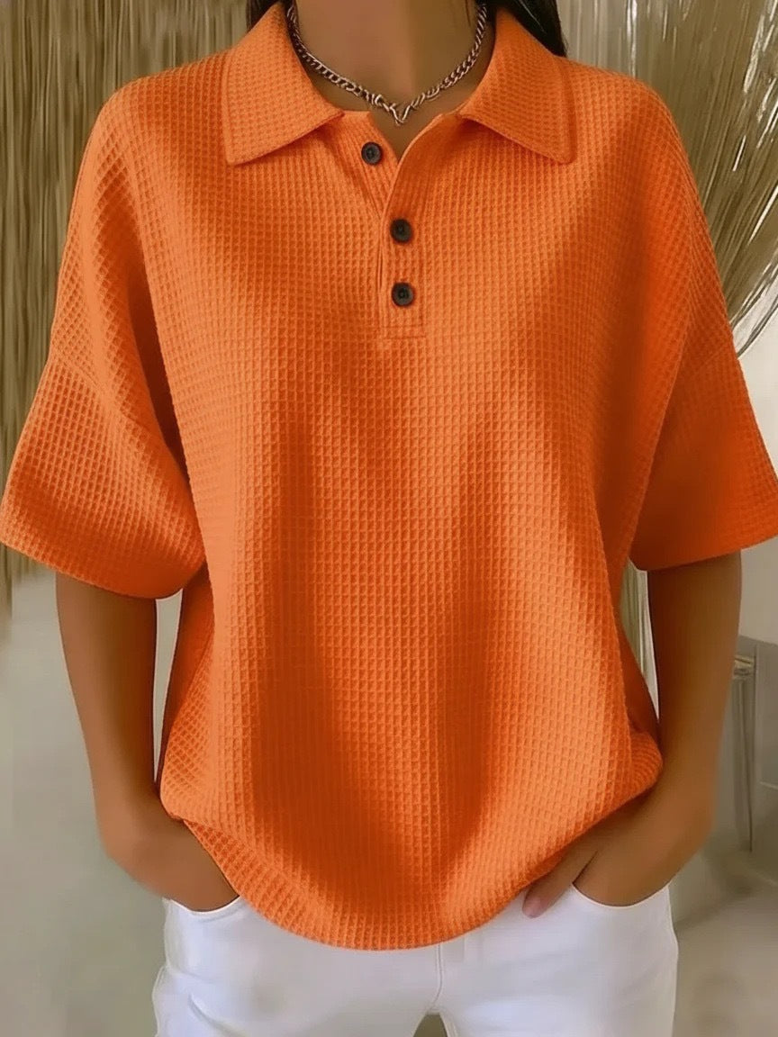 Orange textured polo shirt worn by a person with a neutral background