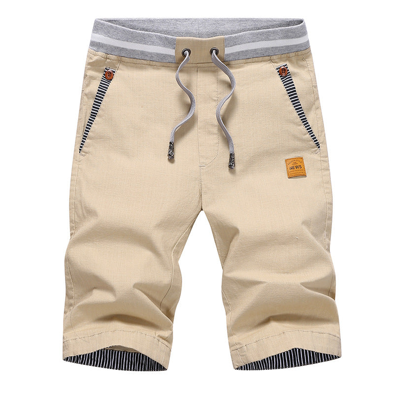 Beige shorts with gray waistband and striped details on a white background